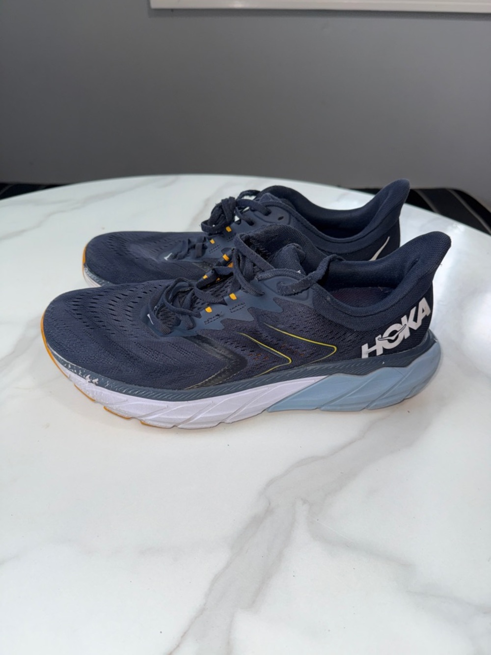 Hoka Navy Running Shoes with White & Light Blue Midsole and Yellow Accents
